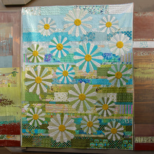 Artisan Flower Quilted Blanket – soft blue, green and cream patchwork-style panels filled with cheerful flowers
