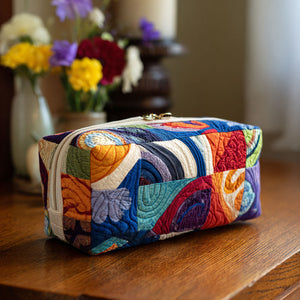 Groovy Waves Quilted Toiletry Bag – sweeping curves in blue, orange, red and cream arranged in lively patchwork-style panels