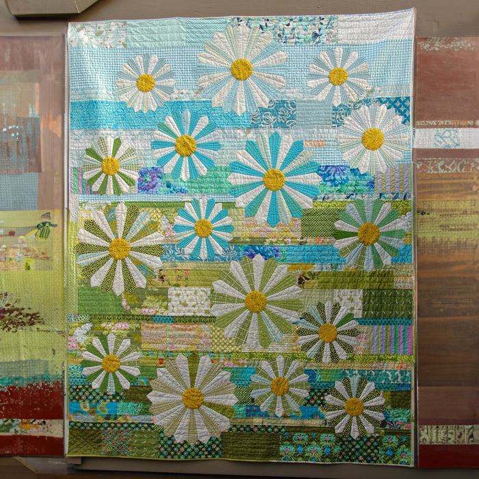 Artisan Flower Quilted Blanket – soft blue, green and cream patchwork-style panels filled with cheerful flowers